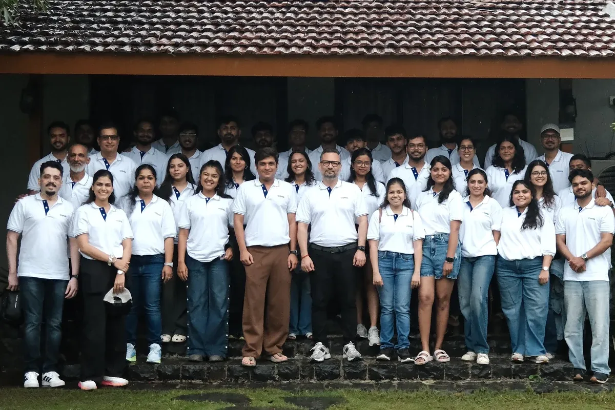 The Copods team standing together outside a tiled-roof house